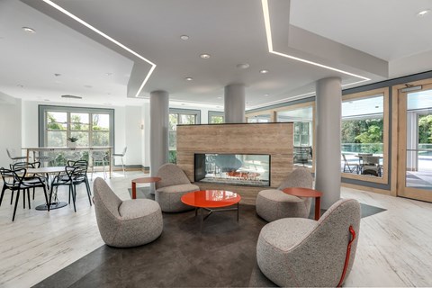 a living room with a fireplace and a table and chairs